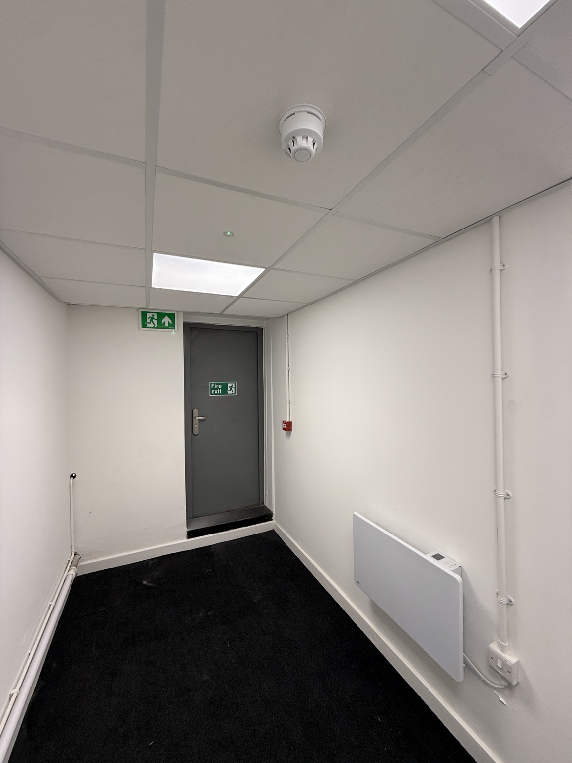 Fire detection, emergency lighting and electric heating within a completed room