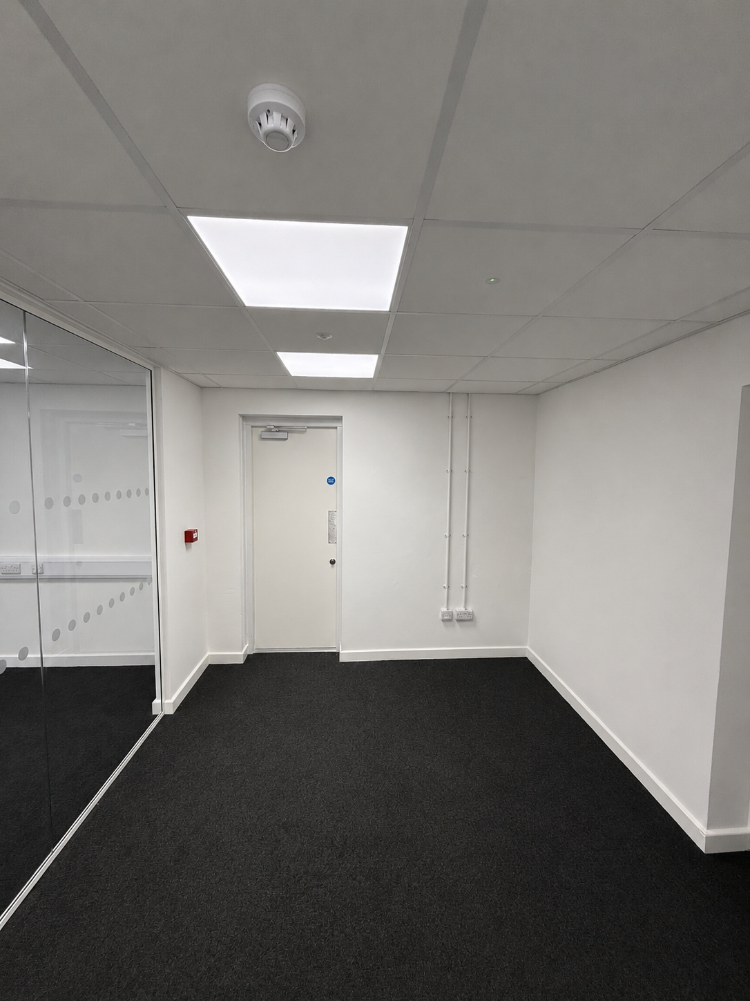 Completed office area with fire detection, emergency lighting and surface containment